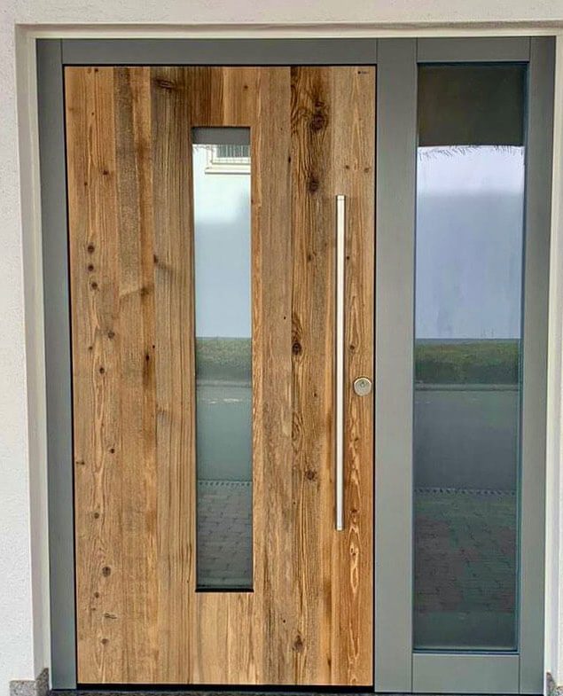 Haustüre aus Holz mit Glaseinsatz und Rahmen aus Aluminium.